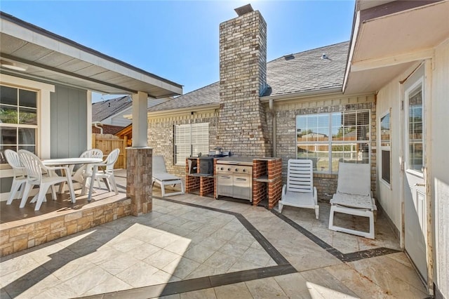 view of patio with outdoor dining space and fence