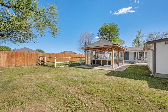 view of yard featuring a patio, a gazebo, and a fenced backyard