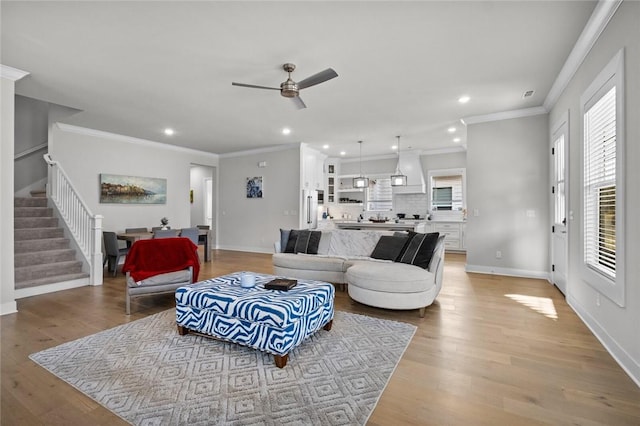 living room featuring stairs, a ceiling fan, recessed lighting, light wood-type flooring, and baseboards