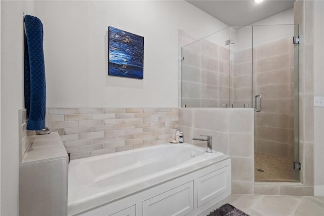 full bathroom featuring a garden tub and a shower stall