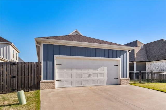 detached garage featuring fence