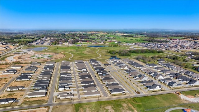 view of property location featuring a nearby body of water and nearby suburban area