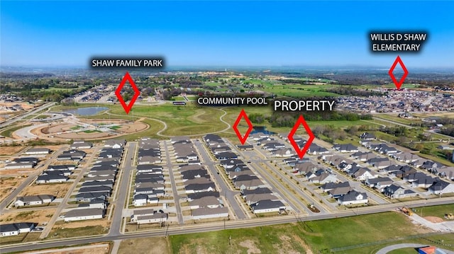 aerial view of property's location featuring nearby suburban area and a nearby body of water