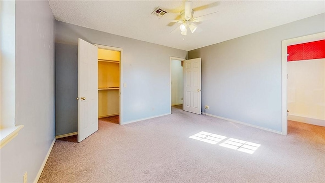 2416 Mulberry St, Rogers, AR 72758 - unfurnished bedroom featuring a walk in closet, carpet flooring, and visible vents