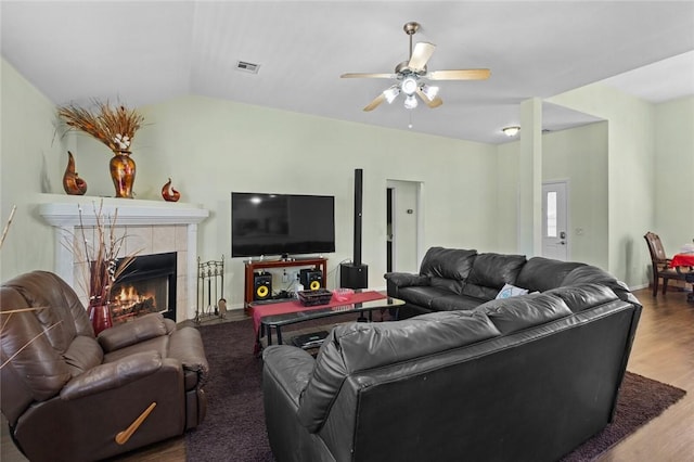 1901 SW Columbus Rd, Bentonville, AR 72713 - living area with a ceiling fan, wood finished floors, a tile fireplace, and vaulted ceiling