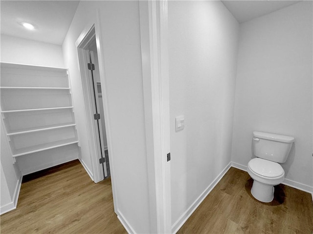 429 W Gosling Isle, Farmington, AR 72730 - bathroom featuring toilet, wood finished floors, and baseboards