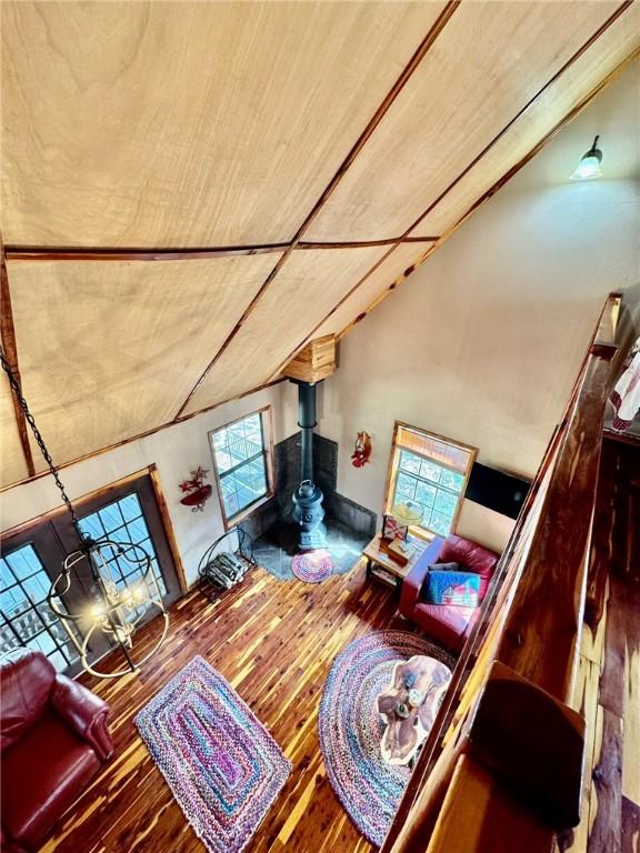 23045 Liberty Trl, Natural Dam, AR 72948 - living room featuring wood finished floors, a wood stove, and lofted ceiling