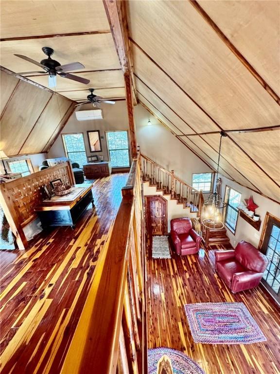 23045 Liberty Trl, Natural Dam, AR 72948 - bedroom featuring multiple windows, vaulted ceiling, and hardwood / wood-style flooring
