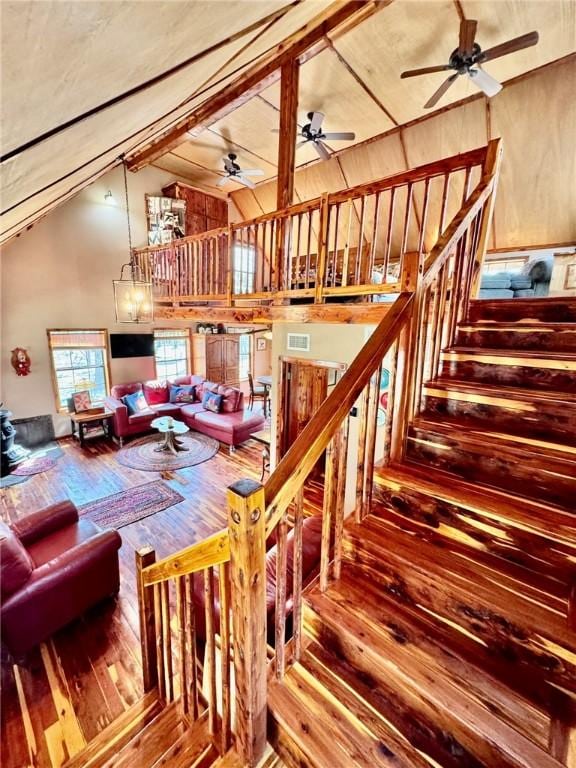 23045 Liberty Trl, Natural Dam, AR 72948 - interior space with high vaulted ceiling, a ceiling fan, visible vents, stairway, and wood-type flooring