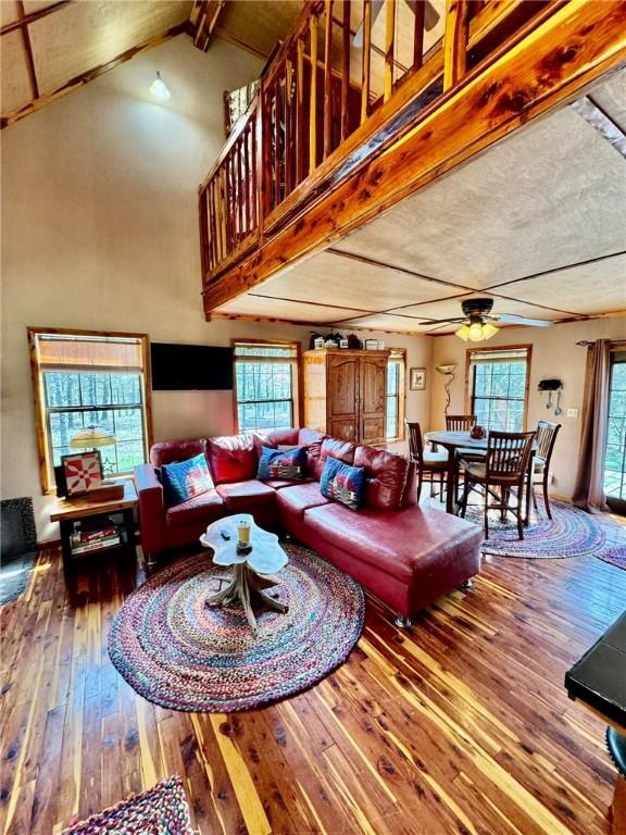 23045 Liberty Trl, Natural Dam, AR 72948 - living room with vaulted ceiling with beams, a ceiling fan, and hardwood / wood-style flooring