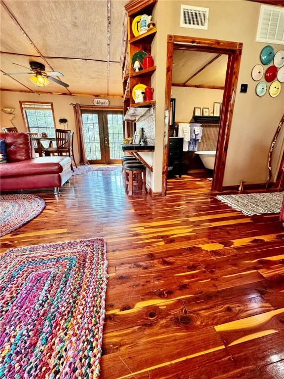 23045 Liberty Trl, Natural Dam, AR 72948 - living room with visible vents, french doors, ceiling fan, and hardwood / wood-style flooring