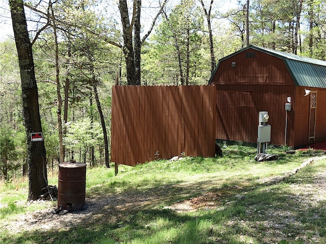 view of yard featuring an outdoor structure and a view of trees