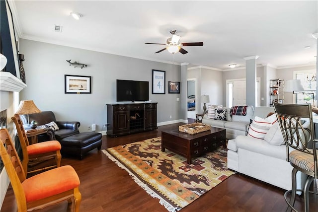 living room with ornamental molding, a ceiling fan, ornate columns, and wood finished floors