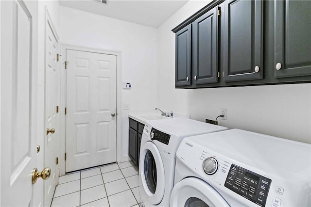 laundry room with light tile patterned flooring, washing machine and dryer, a sink, and cabinet space