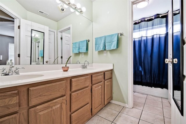 full bathroom with a wealth of natural light, visible vents, tile patterned flooring, and a sink