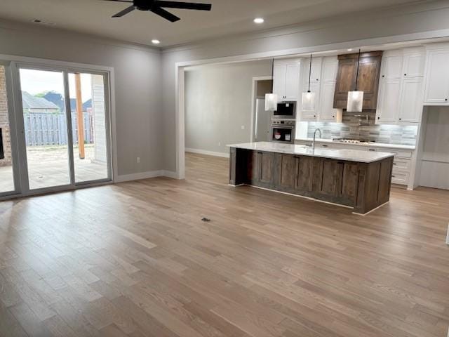 7919 Via Roma Ave, Springdale, AR 72762 - kitchen with a ceiling fan, baseboards, decorative backsplash, light wood-style flooring, and white cabinetry