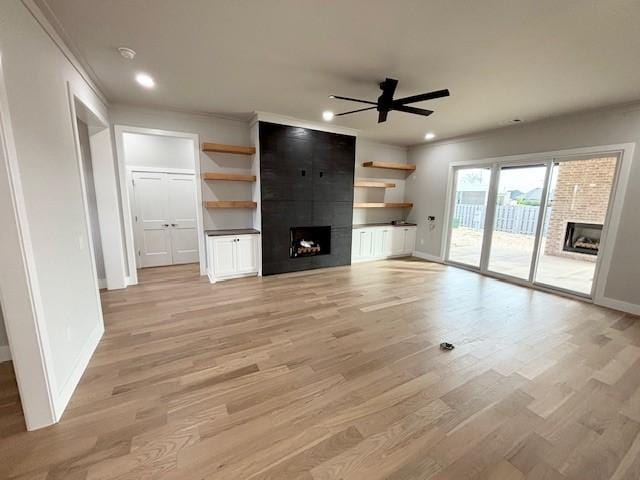 7919 Via Roma Ave, Springdale, AR 72762 - unfurnished living room with a fireplace, a ceiling fan, baseboards, light wood-style flooring, and ornamental molding