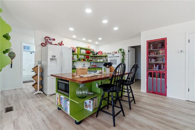 30 Strichen Dr, Bella Vista, AR 72715 - kitchen featuring white appliances, light wood-style flooring, open shelves, visible vents, and butcher block countertops