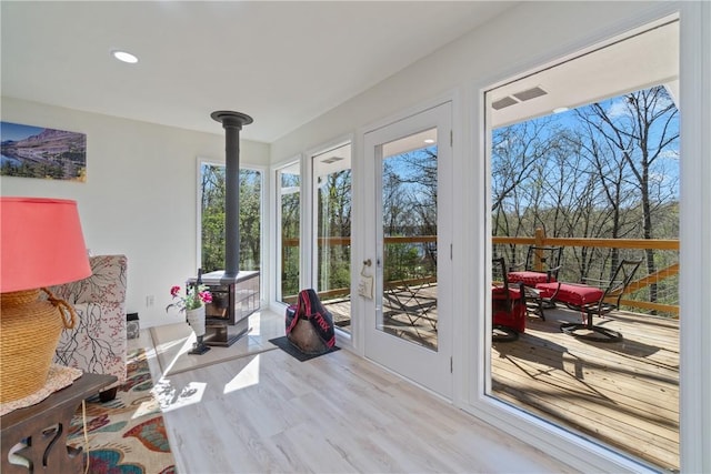 30 Strichen Dr, Bella Vista, AR 72715 - interior space featuring recessed lighting, a wood stove, visible vents, and wood finished floors