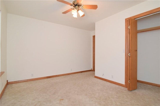 unfurnished bedroom featuring a ceiling fan, baseboards, and light carpet