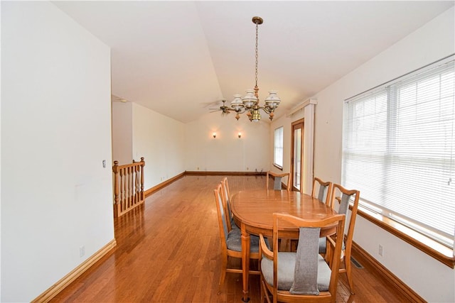 dining room featuring baseboards, a chandelier, and light wood-style floors