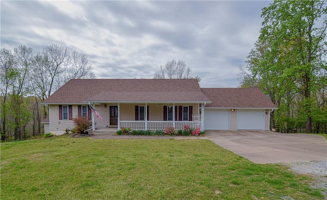 ranch-style house featuring a garage, covered porch, driveway, and a front yard