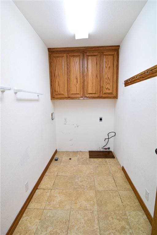 washroom with washer hookup, hookup for an electric dryer, baseboards, and cabinet space