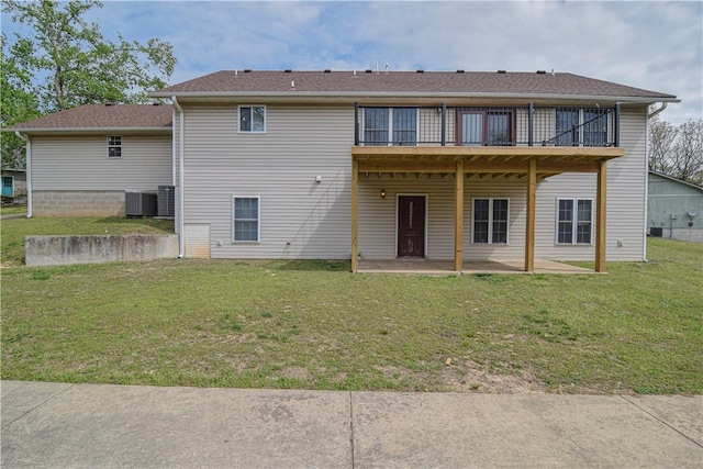 rear view of property with central AC unit, a patio area, a wooden deck, and a yard