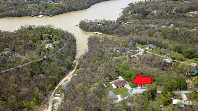 drone / aerial view featuring a water view and a forest view