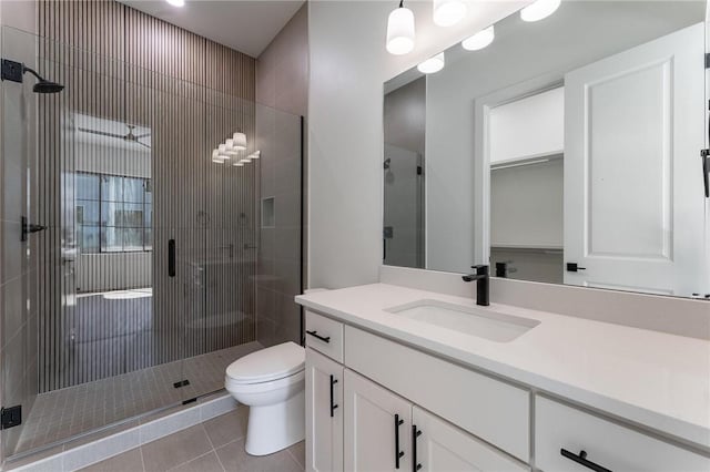3601 Beaverhead, Bentonville, AR 72712 - full bathroom with toilet, tile patterned floors, vanity, and a stall shower