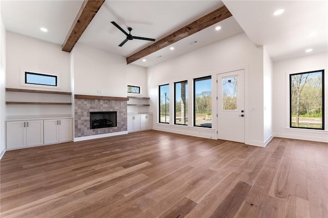 3601 Beaverhead, Bentonville, AR 72712 - unfurnished living room featuring plenty of natural light, light wood-style flooring, beam ceiling, and ceiling fan