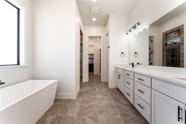 3601 Beaverhead, Bentonville, AR 72712 - full bathroom featuring a sink, a soaking tub, a walk in closet, double vanity, and tiled shower