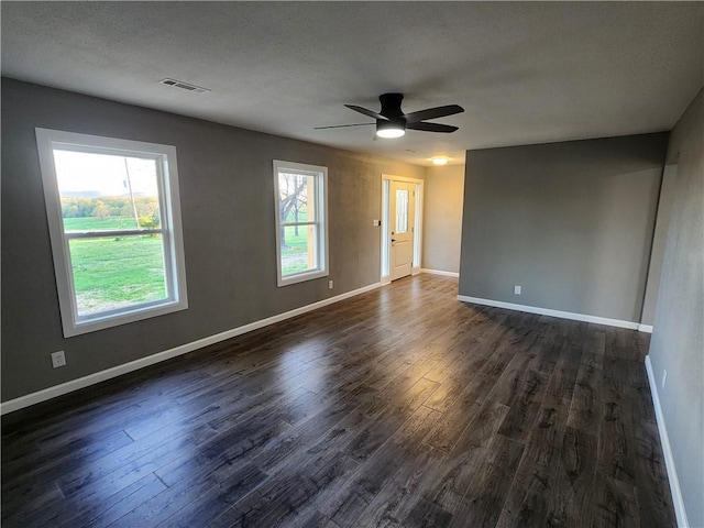 41 Home Ct, Harrison, AR 72601 - unfurnished room featuring dark wood-type flooring, visible vents, ceiling fan, and baseboards