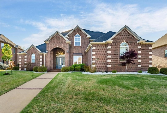 traditional-style home featuring brick siding and a front yard