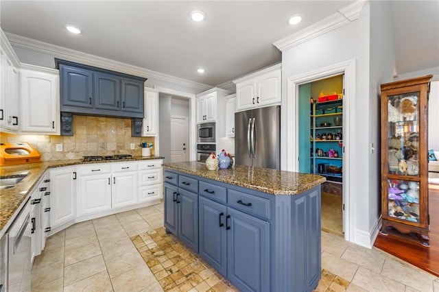 kitchen featuring blue cabinets, ornamental molding, stainless steel appliances, and light tile patterned floors