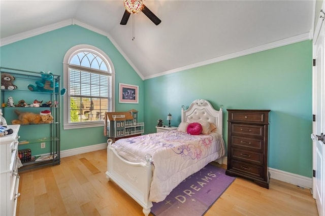 bedroom with lofted ceiling, light wood finished floors, and baseboards