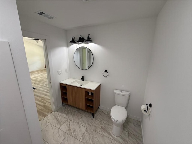 405 S Walnut St, Marshall, AR 72650 - half bath featuring visible vents, vanity, baseboards, toilet, and marble finish floor
