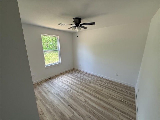 405 S Walnut St, Marshall, AR 72650 - unfurnished room with visible vents, baseboards, ceiling fan, and wood finished floors