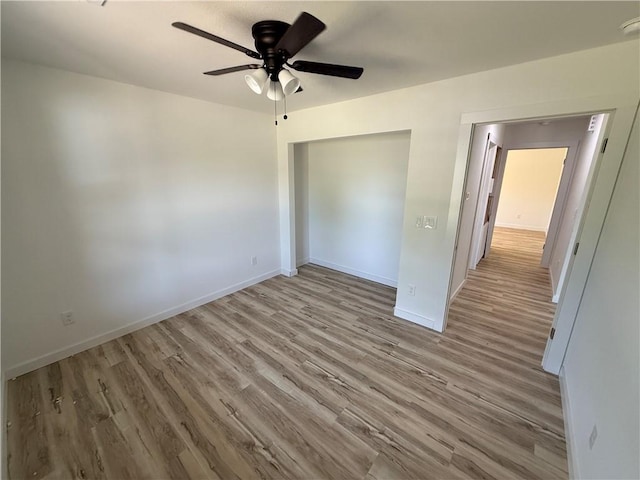 405 S Walnut St, Marshall, AR 72650 - unfurnished bedroom with a ceiling fan, baseboards, wood finished floors, and a closet