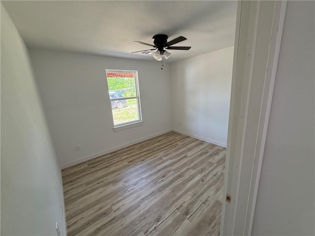 405 S Walnut St, Marshall, AR 72650 - empty room with a ceiling fan, baseboards, and wood finished floors