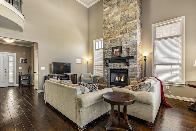 4502 SW Alfalfa Ave, Bentonville, AR 72713 - living room with ornamental molding, dark wood-type flooring, a stone fireplace, and a high ceiling