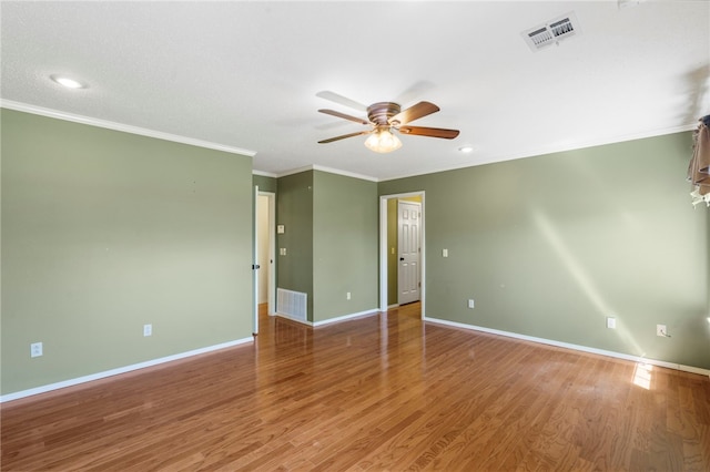 unfurnished room with visible vents, crown molding, baseboards, and ceiling fan