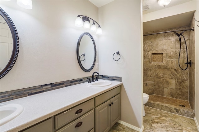 503 Oakwood St, Lowell, AR 72745 - bathroom with toilet, double vanity, baseboards, and a tile shower