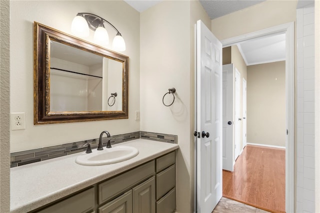 503 Oakwood St, Lowell, AR 72745 - bathroom featuring vanity, ornamental molding, wood finished floors, and baseboards