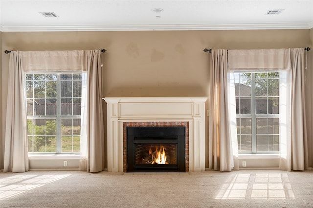 unfurnished living room with a fireplace, carpet, visible vents, and crown molding