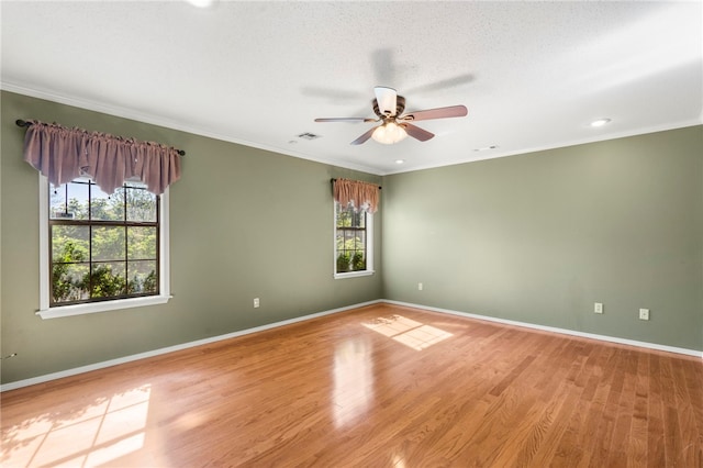 unfurnished room featuring light wood-type flooring, a ceiling fan, and baseboards