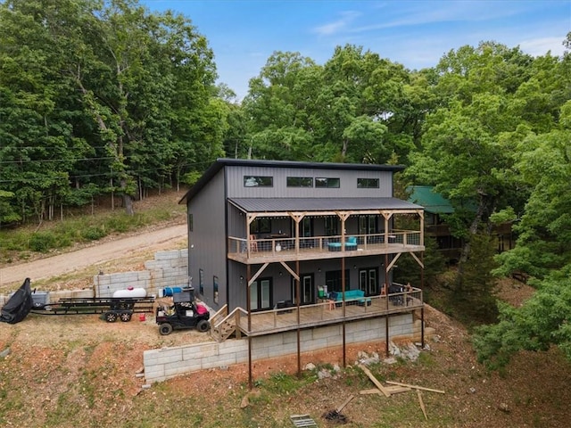 13936 Deepwater Dr, Garfield, AR 72732 - back of house with a wooden deck, metal roof, and a view of trees