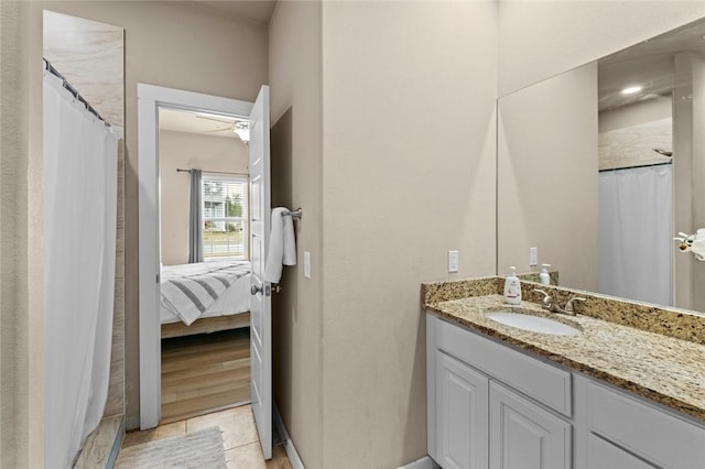 full bath with vanity, ceiling fan, and tile patterned flooring