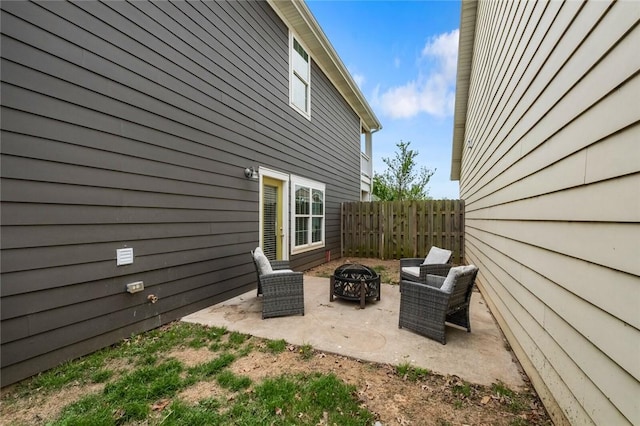 view of patio / terrace with fence and an outdoor fire pit