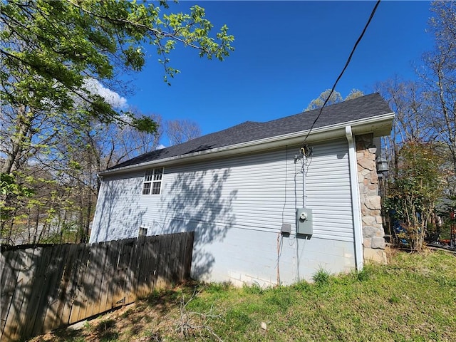 1 Binham Ln, Bella Vista, AR 72715 - view of property exterior featuring fence and a shingled roof